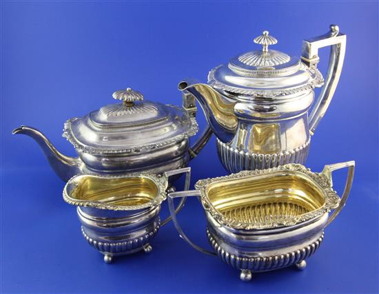 A George III demi-fluted silver four piece tea and coffee set by J.W. Story & William Elliot, gross 78 oz.